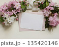 Blank paper greeting card, pink envelope, surrounded by Japanese cherry blossoms, apple flowers, silk ribbon. Beuatiful floral mockup for wedding invitations, stationery, greetings, or spring messages 135420146