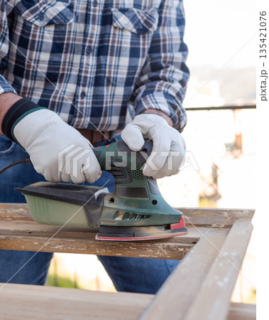 Carpenter at work, restoring an old wooden window. Carpentry. Carpenter at work, restoring an old wooden window. Carpentry. 135421076