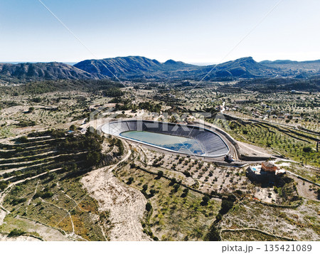 Aerial view of water reservoir surrounded by terraced farmland Aerial view of water reservoir surrounded by terraced farmland 135421089