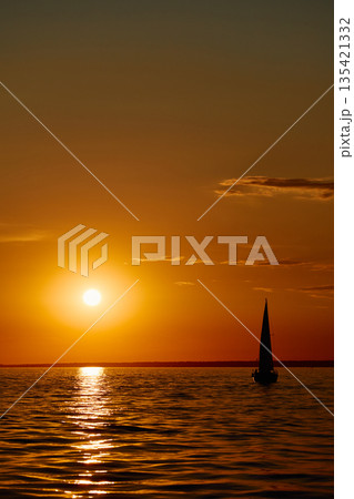 Sailing regatta in the Gulf of Finland at sunset, few sailing yachts competing in a race, splashing water from under the boats, teamwork, board the boat 135421332