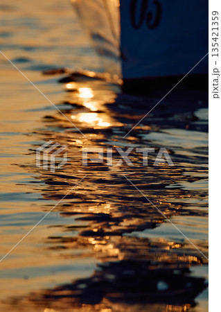 bow of a sailing boat with bowsprit at sailing regatta in the Gulf of Finland at sunset, sailing yacht competing in a race, splashing water from under the boat, teamwork, board the boat bow of a sailing boat with bowsprit at sailing regatta in the Gulf of Finland at sunset, sailing yacht competing in a race, splashing water from under the boat, teamwork, board the boat 135421359
