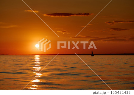 Sailing regatta in the Gulf of Finland at sunset, few sailing yachts competing in a race, splashing water from under the boats, teamwork, board the boat Sailing regatta in the Gulf of Finland at sunset, few sailing yachts competing in a race, splashing water from under the boats, teamwork, board the boat 135421435