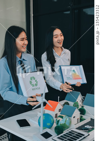 Hands of adult Asian business professionals analyzing ESG financial data and renewable energy project plans Hands of adult Asian business professionals analyzing ESG financial data and renewable energy project plans 135423312
