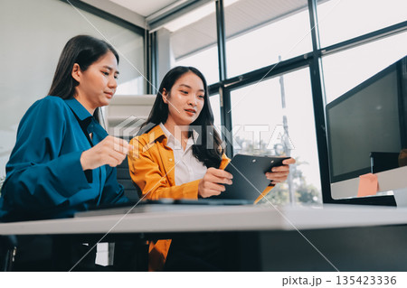 Meeting, tablet and business people in office for discussion, collaboration or planning project. Teamwork, feedback and employees talking for product development, conversation or idea at design firm 135423336