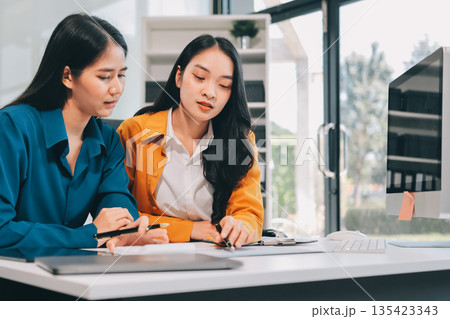 Businesswomen having discussion in office Businesswomen having discussion in office 135423343