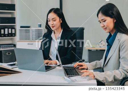 Businesswomen having discussion in office Businesswomen having discussion in office 135423345
