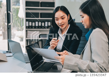 Businesswomen having discussion in office Businesswomen having discussion in office 135423347
