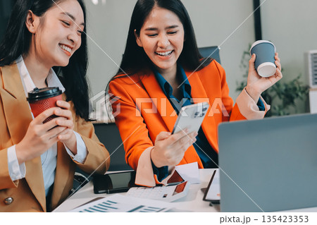 Businesswomen having discussion in office Businesswomen having discussion in office 135423353