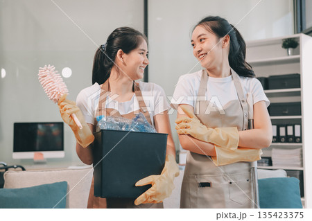 Cleaners clean empty office spaces Cleaners clean empty office spaces 135423375