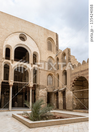 Qalawun complex interior at Al-Muizz Street. Features Islamic architecture with arches, intricate designs, and a central courtyard with greenery. 135424088