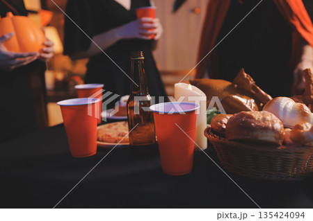 Friends enjoying a Halloween party at a bar making a toast 135424094