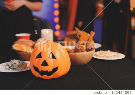Friends enjoying a Halloween party at a bar making a toast 135424097