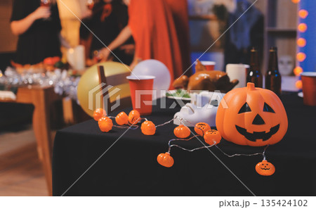 Friends enjoying a Halloween party at a bar making a toast 135424102