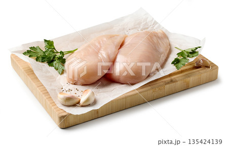 fresh chicken breast meat on cutting board fresh chicken breast meat on cutting board 135424139