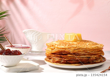 Maslenitsa concept. Delicious Russian pancakes with jam, soft cottage cheese, preserves, sour cream, and honey on a marble table. Healthy breakfast from natural ingredients, natural products Maslenitsa concept. Delicious Russian pancakes with jam, soft cottage cheese, preserves, sour cream, and honey on a marble table. Healthy breakfast from natural ingredients, natural products 135424154