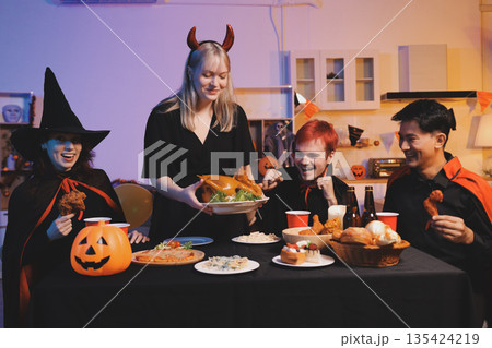 Friends enjoying a Halloween party at a bar making a toast Friends enjoying a Halloween party at a bar making a toast 135424219