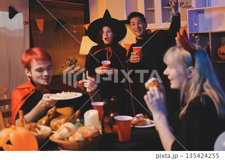 Friends enjoying a Halloween party at a bar making a toast Friends enjoying a Halloween party at a bar making a toast 135424255
