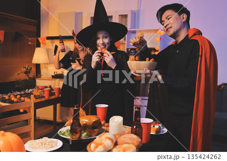 Friends enjoying a Halloween party at a bar making a toast Friends enjoying a Halloween party at a bar making a toast 135424262