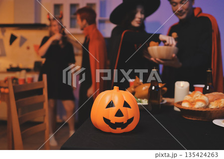 Friends enjoying a Halloween party at a bar making a toast 135424263