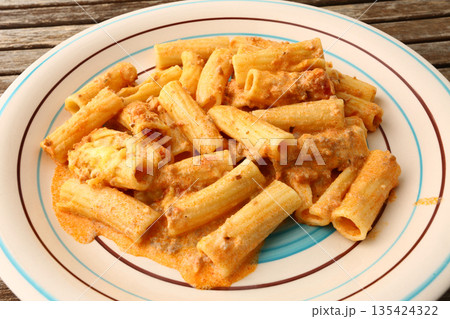 Classic macaroni bolognese with tomato meat sauce and grated cheese topping. Classic macaroni bolognese with tomato meat sauce and grated cheese topping. 135424322