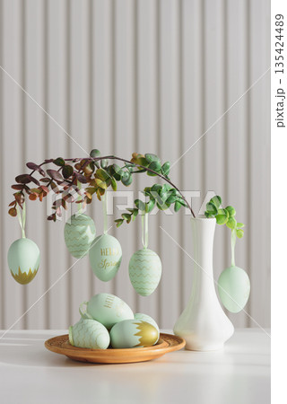 Hanging Easter Eggs and Spring Branches in Vase. Festive Pastel Decor 135424489