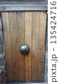 Historic wooden door with metal boss in Gdansk 135424716