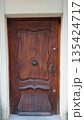Historic wooden door with carved details 135424717