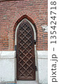 Gothic wooden door with carved geometric pattern 135424718