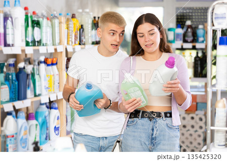 Couple man and woman choosing detergent in store 135425320