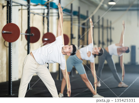 Young guy doing warm-up with stick Young guy doing warm-up with stick 135425331