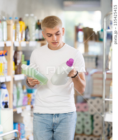Male consumer with household chemical products for washing indoors 135425415