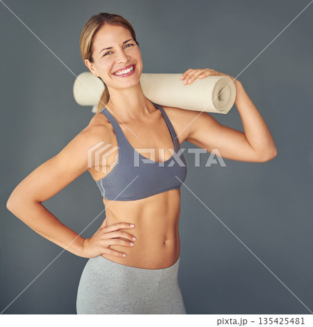 Happy woman, portrait and fitness body with yoga mat for zen workout or exercise against a grey studio background. Female person or yogi with smile for healthy wellness, mental health and pilates 135425481