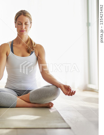 Calm woman, yoga and meditation on mat for spiritual wellness, zen or healthy workout on floor at home. Relaxed female person or yogi meditating for mindful exercise or awareness with mockup space Calm woman, yoga and meditation on mat for spiritual wellness, zen or healthy workout on floor at home. Relaxed female person or yogi meditating for mindful exercise or awareness with mockup space 135425492