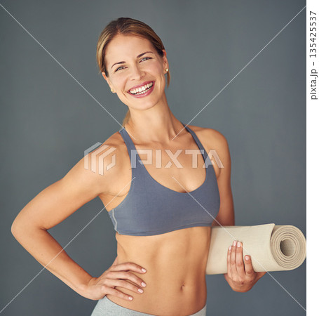 Happy woman, fitness and portrait for yoga exercise, zen workout or healthy body against a grey studio background. Female person or yogi with smile and mat for spiritual wellness and mental health 135425537