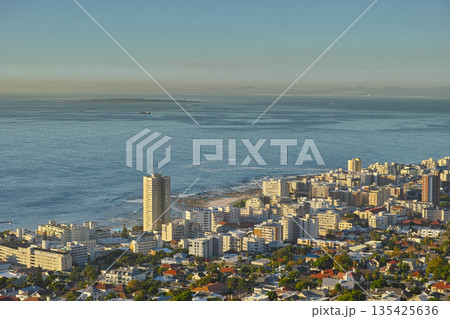 Cityscape, urban buildings and architecture by ocean, infrastructure and property development in metro. Skyline, cbd and seaside with city skyscraper, Cape Town and mockup space in summer sunshine 135425636