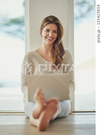 Smile, laptop and portrait of woman on floor at home, relax and sitting on ground. Computer, happy and person from Norway typing, writing blog for social media or email, internet or web research. Smile, laptop and portrait of woman on floor at home, relax and sitting on ground. Computer, happy and person from Norway typing, writing blog for social media or email, internet or web research. 135425654