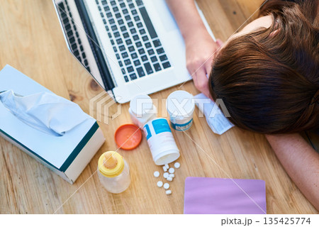Top view, sick and woman with a laptop, sleeping and burnout with medicine, tired and career. Female person, professional or employee with medication, healthcare issue or problem with pills or tissue Top view, sick and woman with a laptop, sleeping and burnout with medicine, tired and career. Female person, professional or employee with medication, healthcare issue or problem with pills or tissue 135425774