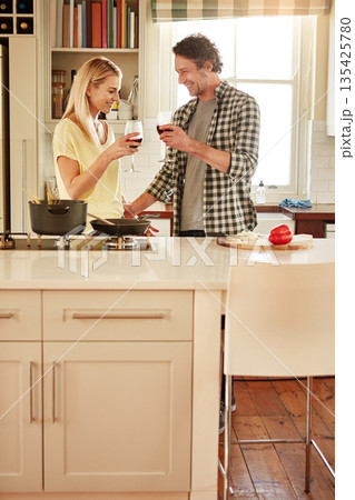 Toast, funny or happy couple cooking food for a healthy vegan diet meal together with love at home. Smile, cheers or woman drinking wine laughing in house kitchen to celebrate with a mature husband 135425780