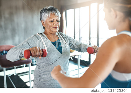 Coaching, dumbbell and fitness with old woman and personal trainer for support, health or physiotherapy. Training, weightlifting and workout with senior client and female trainer for elderly exercise Coaching, dumbbell and fitness with old woman and personal trainer for support, health or physiotherapy. Training, weightlifting and workout with senior client and female trainer for elderly exercise 135425804