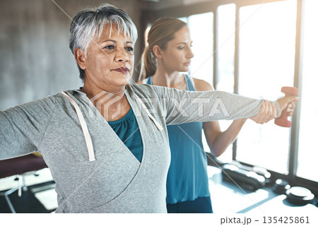 Dumbbell, physiotherapy and old woman with personal trainer for fitness, wellness or rehabilitation. Health, workout or retirement with senior patient and physiotherapist in gym for support training 135425861