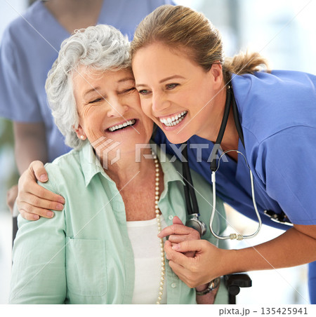 Nurse, senior woman and happy hug of caregiver and smile with support and care in hospital. Wheelchair, patient and healthcare employee help person with a disability with love in a health clinic Nurse, senior woman and happy hug of caregiver and smile with support and care in hospital. Wheelchair, patient and healthcare employee help person with a disability with love in a health clinic 135425941