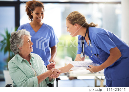 Handshake, nurse and senior woman in wheelchair with medical results and surgery success news. Hospital, healthcare and clinic with women and nursing staff with care and support of elderly person 135425945
