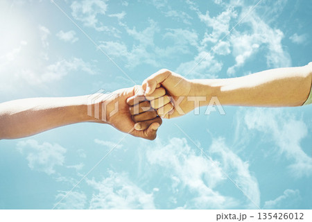 Fist bump, people and blue sky with motivation, success and teamwork outdoor. Support, friends and winning hand sign in summer with celebration and agreement showing solidarity in nature from victory Fist bump, people and blue sky with motivation, success and teamwork outdoor. Support, friends and winning hand sign in summer with celebration and agreement showing solidarity in nature from victory 135426012