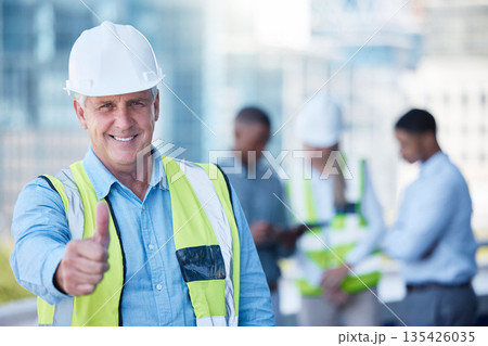 Portrait, thumbs up and a senior man construction worker outdoor on a building site with his team in the background. Management, motivation and support with a mature male architect saying thank you Portrait, thumbs up and a senior man construction worker outdoor on a building site with his team in the background. Management, motivation and support with a mature male architect saying thank you 135426035