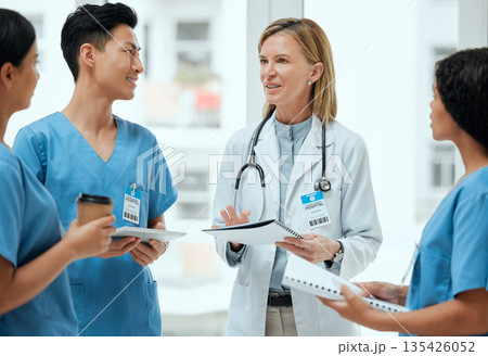 Teamwork, discussion or doctors with paperwork in meeting planning a surgery strategy in collaboration. Leadership, tablet or surgeons talking or speaking of healthcare reports, feedback or research Teamwork, discussion or doctors with paperwork in meeting planning a surgery strategy in collaboration. Leadership, tablet or surgeons talking or speaking of healthcare reports, feedback or research 135426052