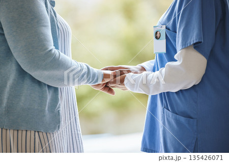 Woman patient, nurse and holding hands for support, healthcare and kindness at nursing home. Senior person and caregiver together for trust, elderly care and help in retirement with kind empathy Woman patient, nurse and holding hands for support, healthcare and kindness at nursing home. Senior person and caregiver together for trust, elderly care and help in retirement with kind empathy 135426071