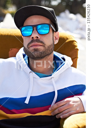 Face, fashion and man with glasses in a city, chill and attitude, young and stylish on blurred background. Trendy, sunglasses and male person with confidence, casual and cool clothes while downtown 135426230