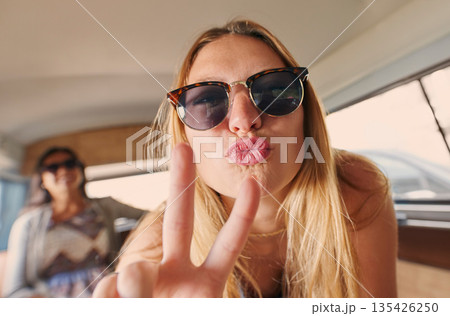 Selfie, peace sign or portrait of happy woman on road trip with freedom on holiday travel in summer in car. Funny face, cool sunglasses or silly gen z girl tourist for social media on vacation break 135426250