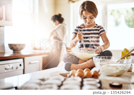 Messy, flour and girl baking in a kitchen with parent for learning about Independence, child development or food at home. Dirty, fun or young female kid mixing cake or cookies in a bowl while cooking Messy, flour and girl baking in a kitchen with parent for learning about Independence, child development or food at home. Dirty, fun or young female kid mixing cake or cookies in a bowl while cooking 135426294