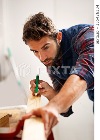 Man, wood and pencil for measure for construction, home development and building renovation. Carpenter, maintenance employee and male repairman worker on a contractor job of builder working in house Man, wood and pencil for measure for construction, home development and building renovation. Carpenter, maintenance employee and male repairman worker on a contractor job of builder working in house 135426334